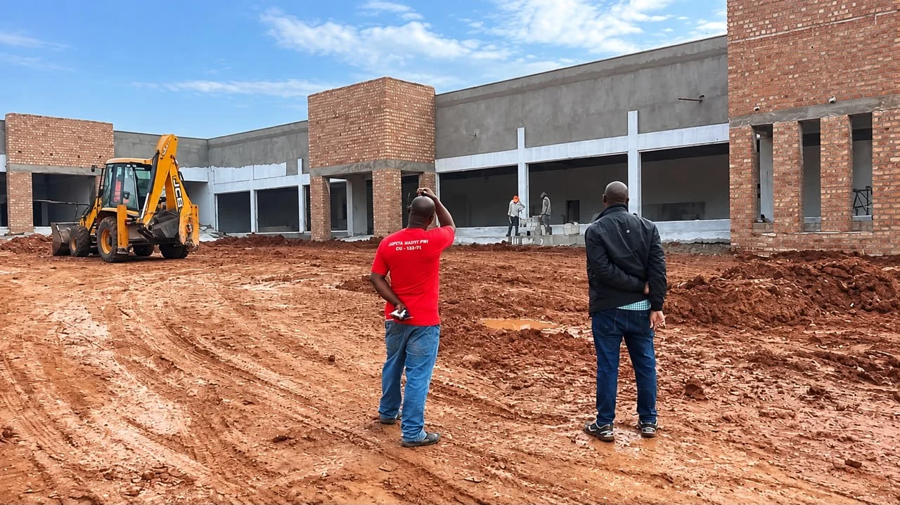 Site activity in front of a commercial building under development.